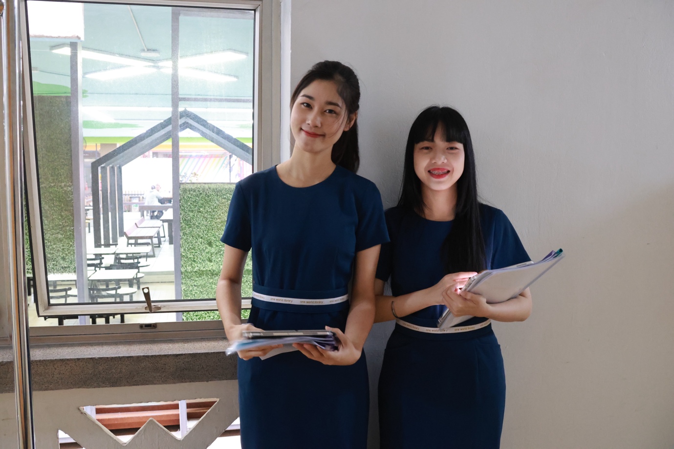 A couple of women in blue dresses

Description automatically generated