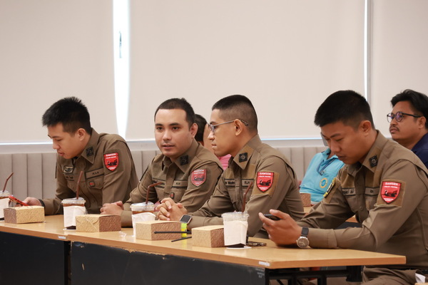 A group of men in uniform sitting at a table
Description automatically generated