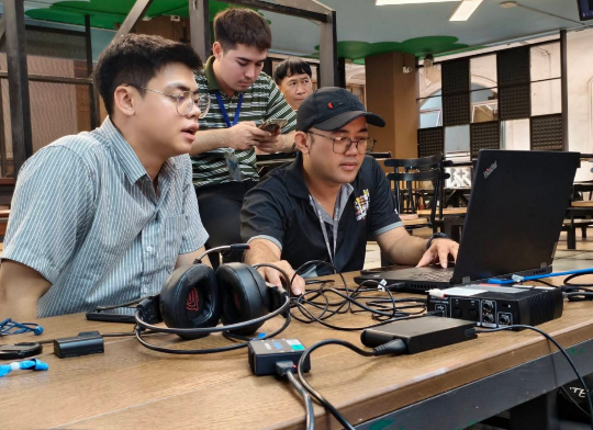 A group of men sitting at a table with a computer

AI-generated content may be incorrect.