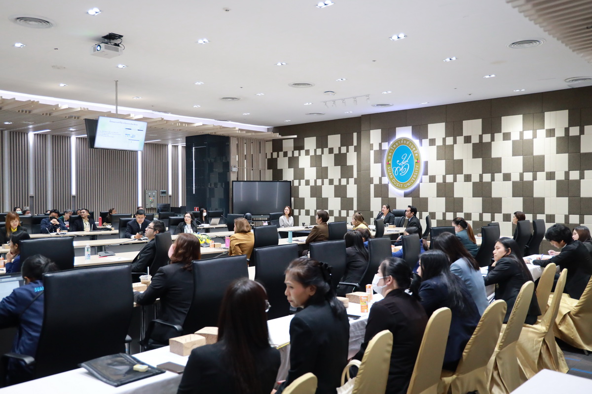 A group of people in a conference room
Description automatically generated