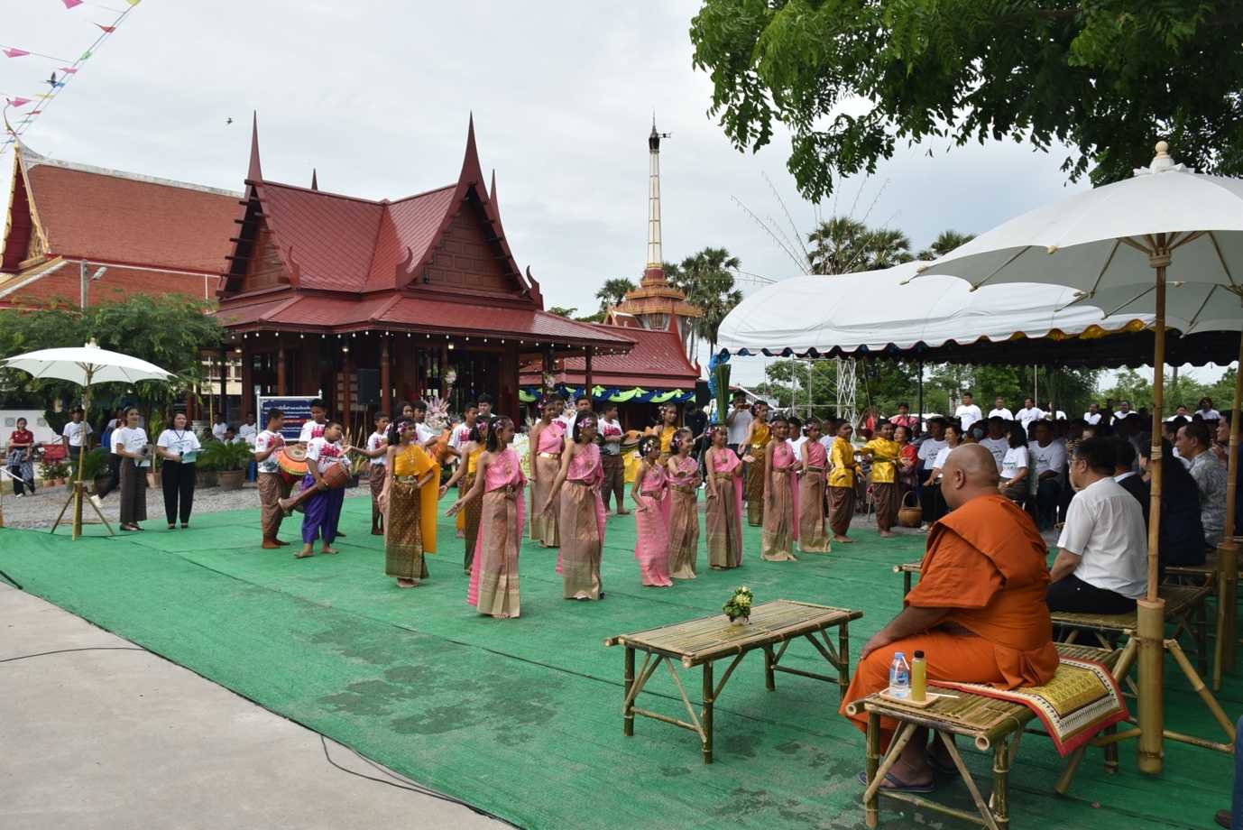 A group of people performing a traditional dance

Description automatically generated