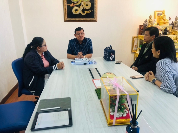 A group of people sitting around a table

Description automatically generated