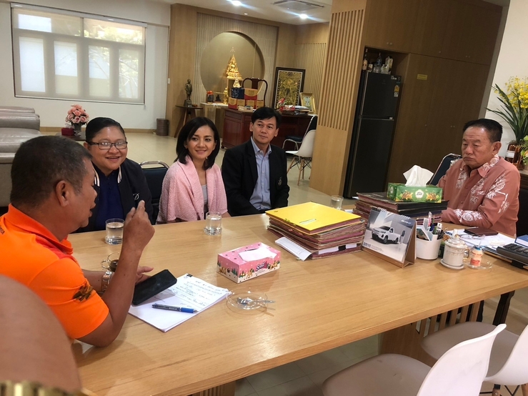 A group of people sitting around a table
Description automatically generated