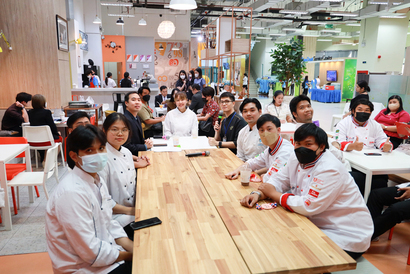 A group of people sitting around a table

Description automatically generated