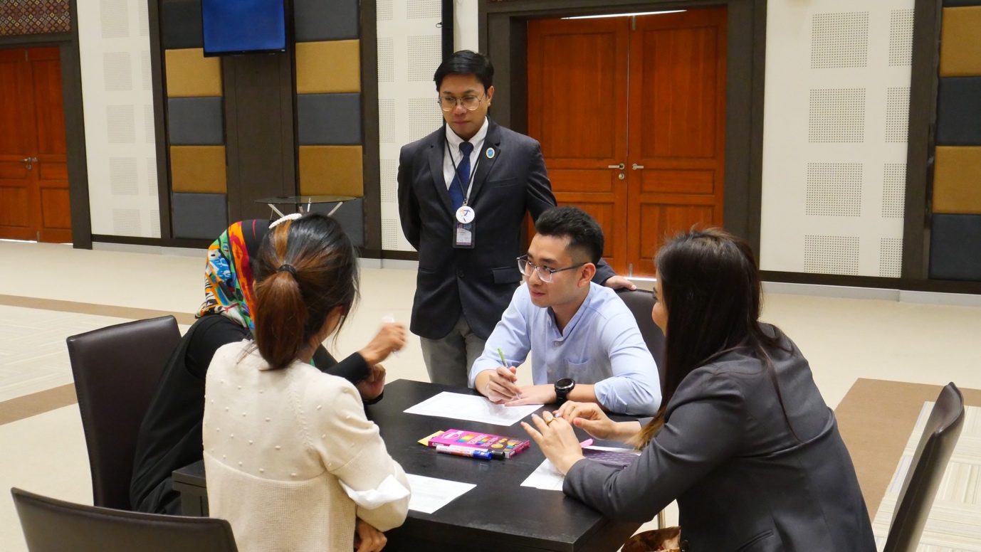 A group of people sitting around a table

Description automatically generated