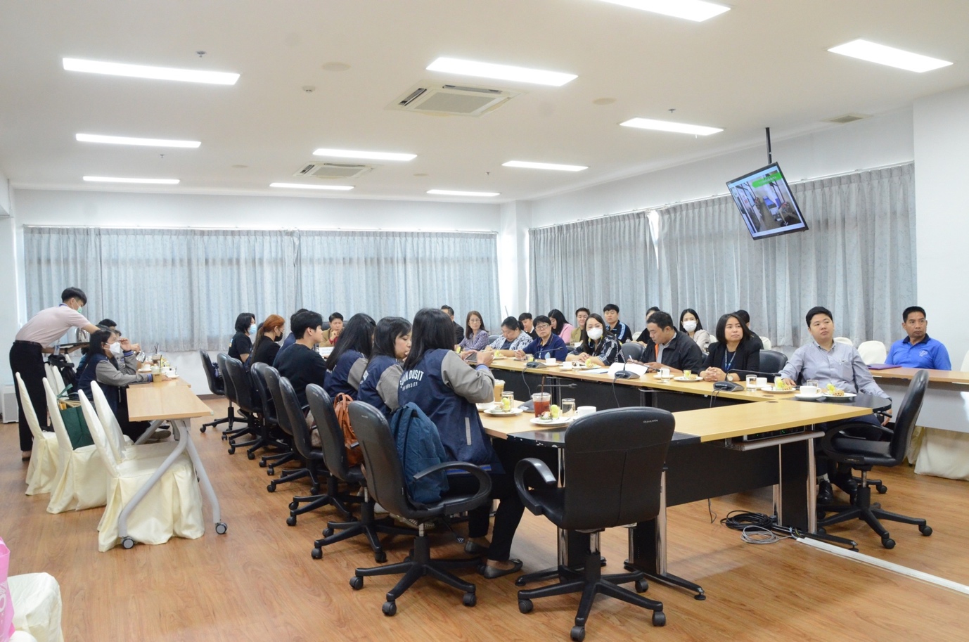 A group of people sitting at a table

Description automatically generated