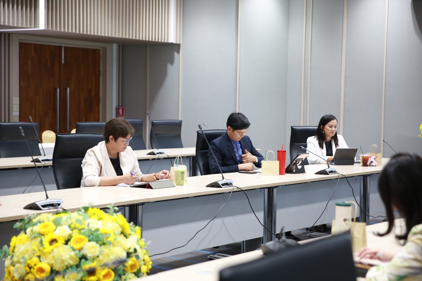 A group of people sitting at a table
Description automatically generated