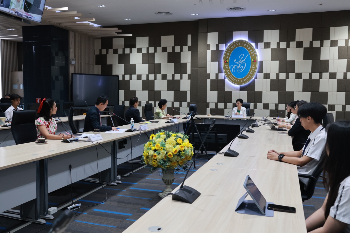 A group of people sitting at a table

Description automatically generated