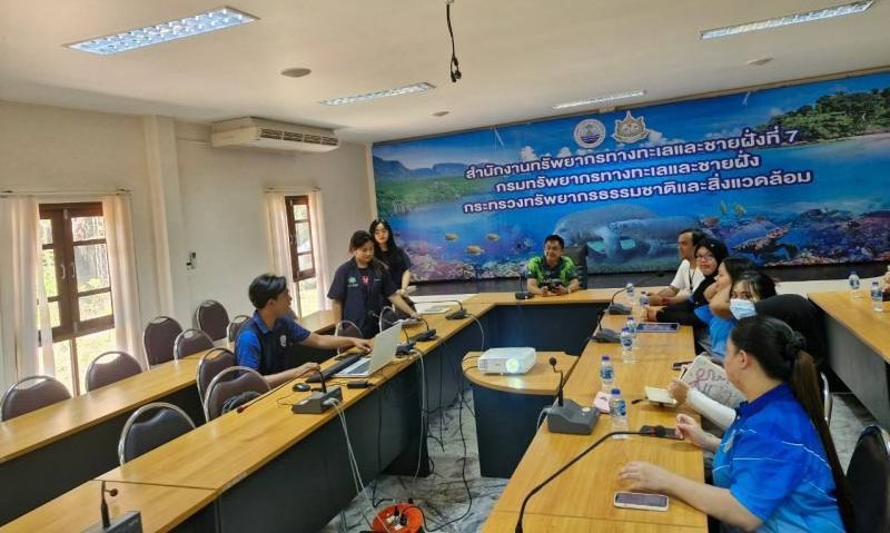 A group of people sitting at long tables

Description automatically generated