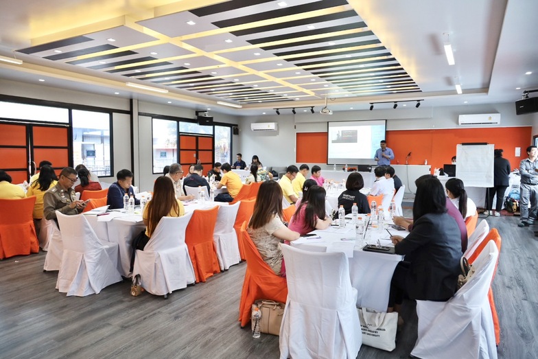 A group of people sitting at tables

Description automatically generated