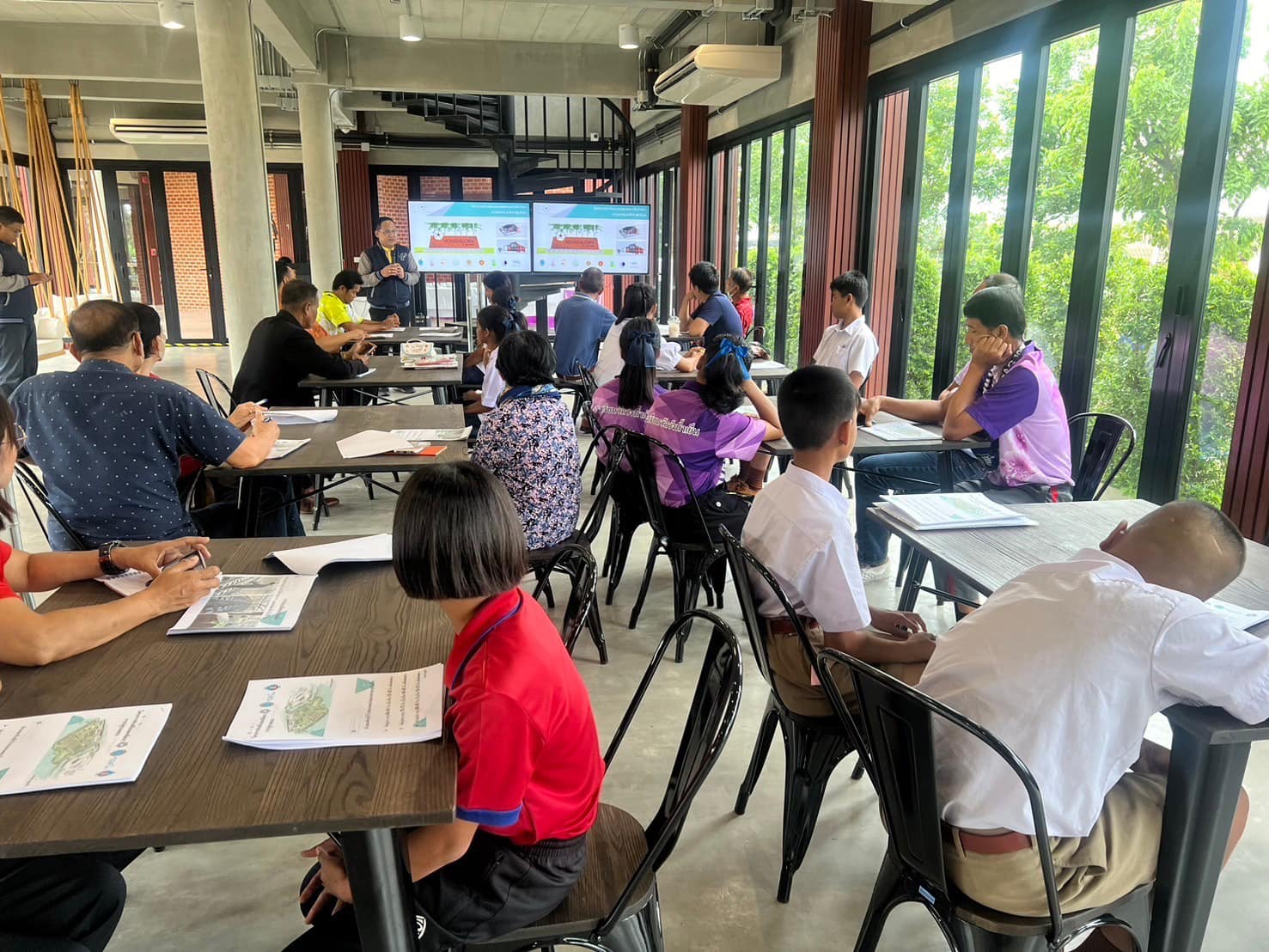 A group of people sitting at tables in a room

Description automatically generated