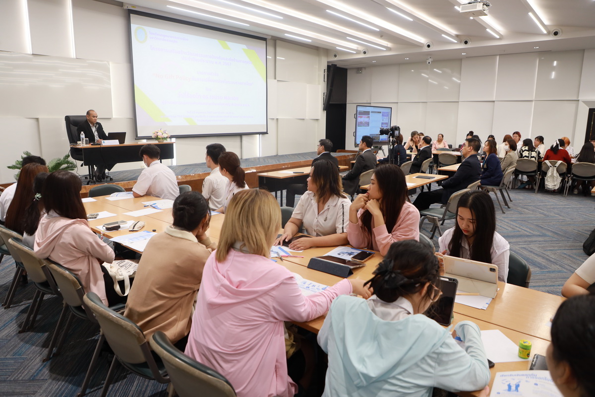 A group of people sitting at tables in a room
Description automatically generated