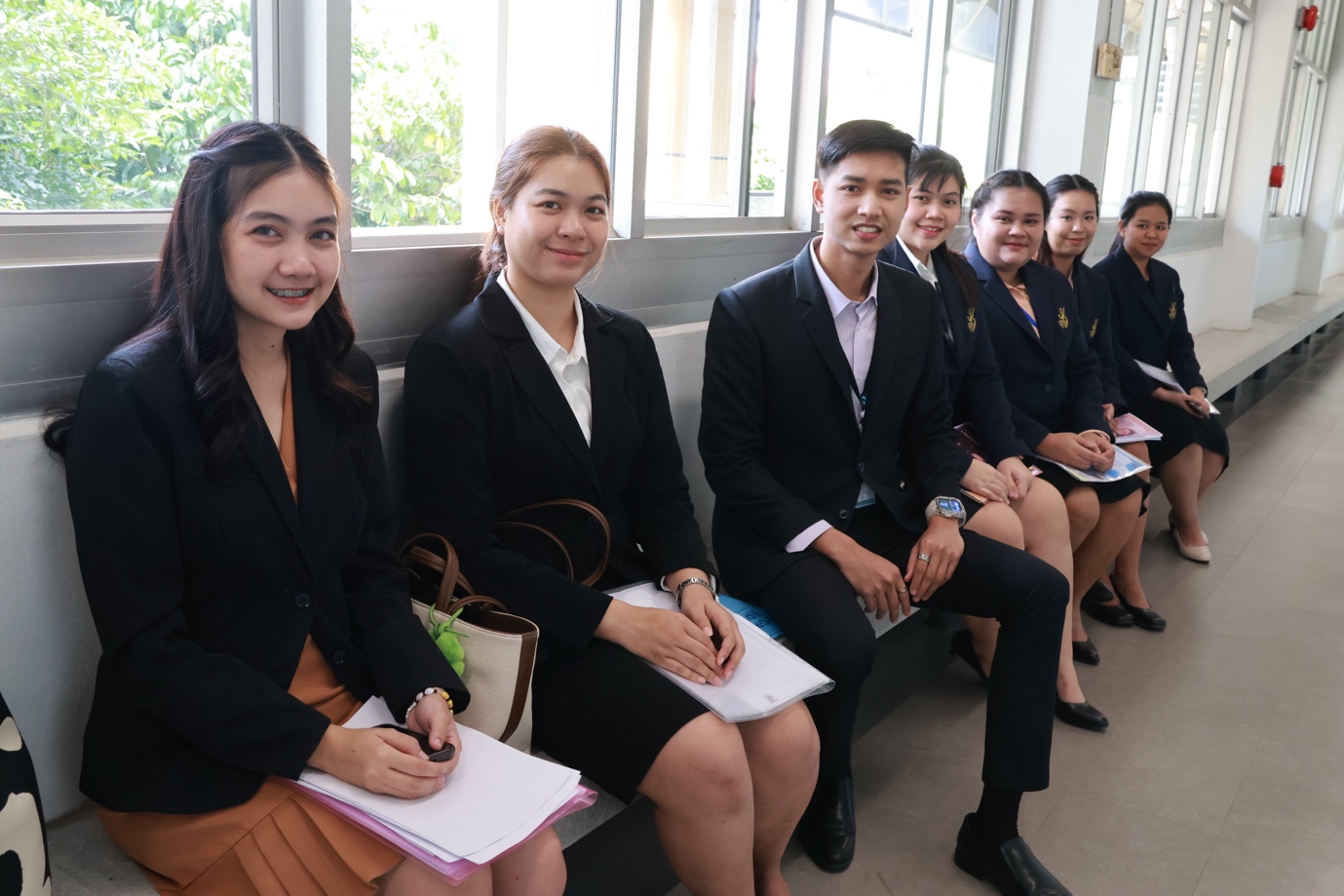 A group of people sitting on a bench

Description automatically generated
