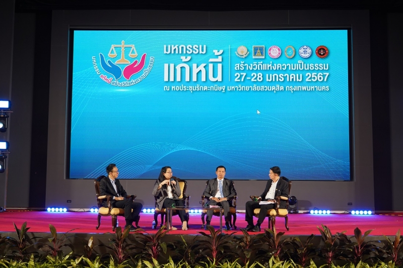 A group of people sitting on a stage
Description automatically generated