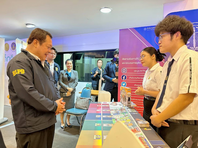 A group of people standing around a table

Description automatically generated