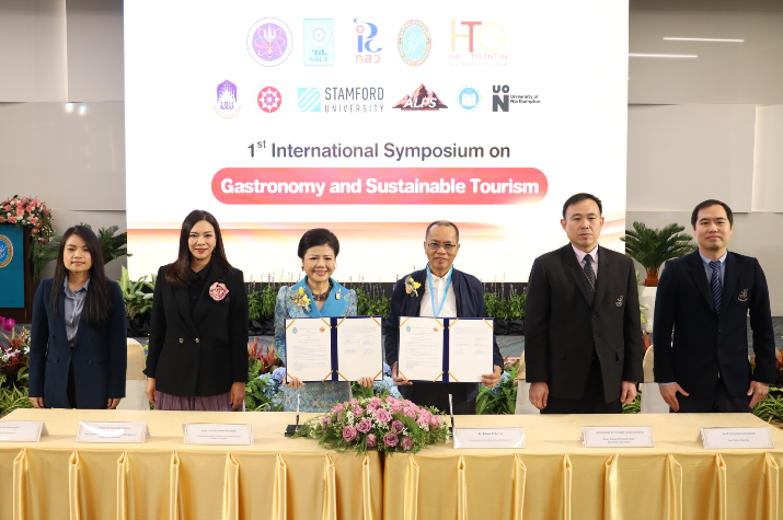 A group of people standing at a table with certificates

AI-generated content may be incorrect.