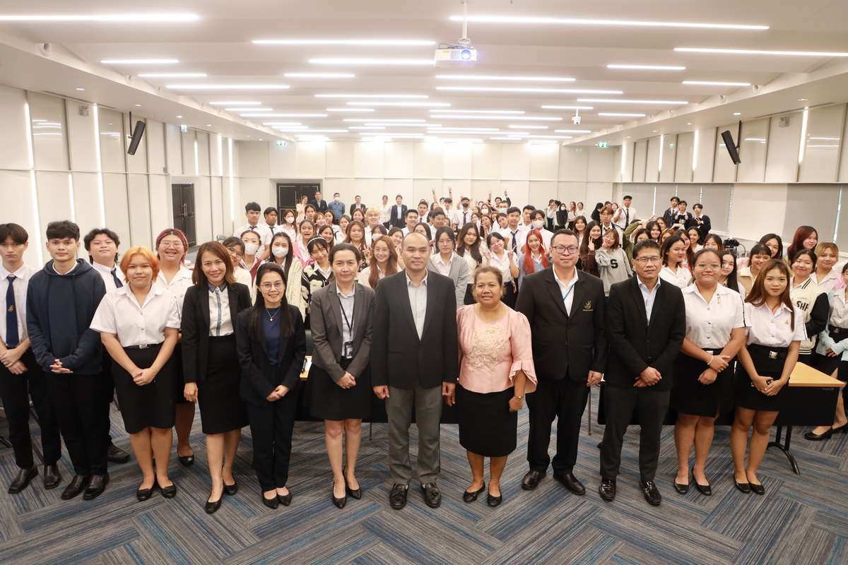 A group of people standing in a room
Description automatically generated