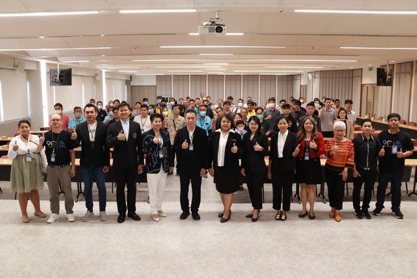 A group of people standing in a room

Description automatically generated