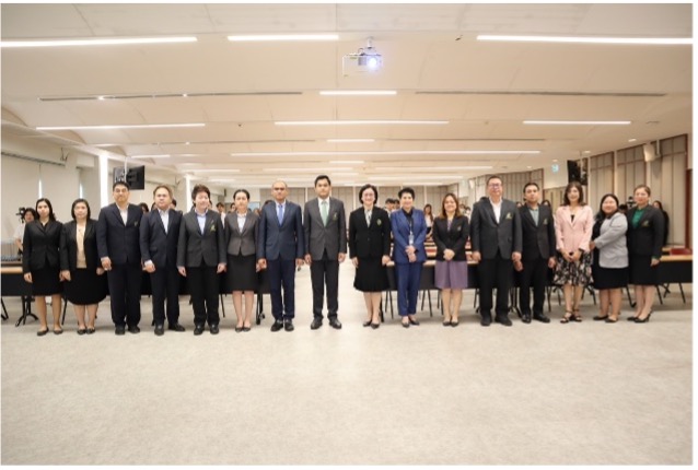 A group of people standing in a room

Description automatically generated