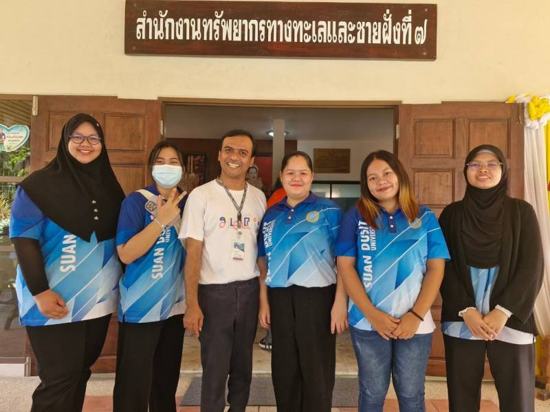 A group of people standing in front of a building

Description automatically generated