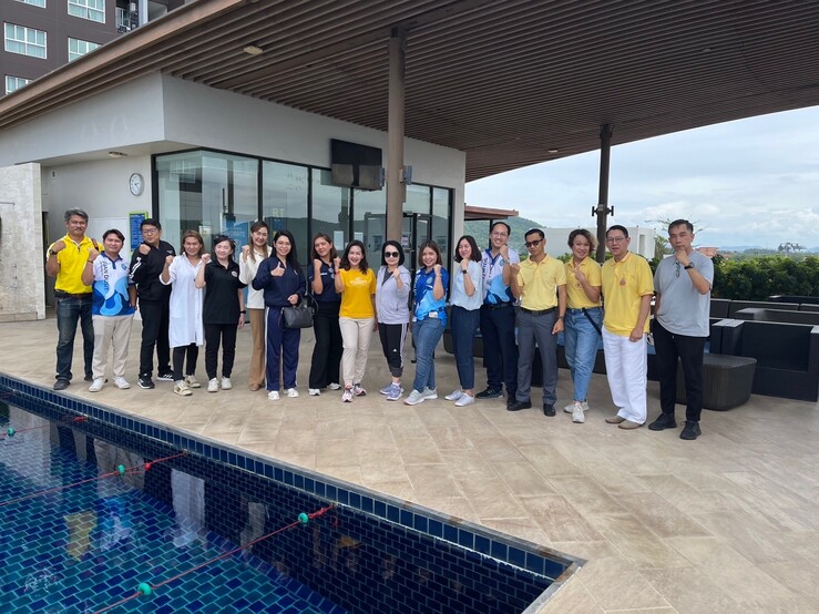 A group of people standing in front of a pool
AI-generated content may be incorrect.