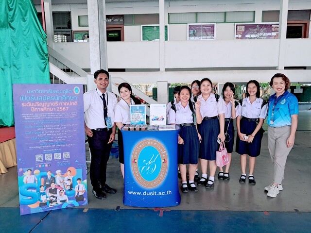 A group of people standing in front of a sign

AI-generated content may be incorrect.