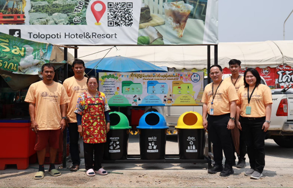 A group of people standing in front of a sign

AI-generated content may be incorrect.