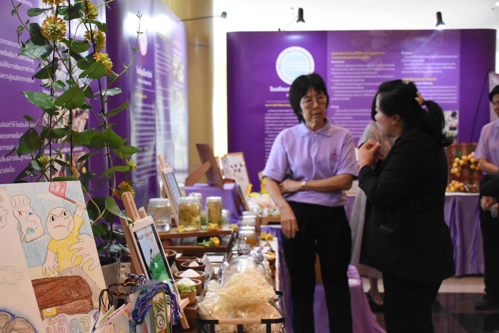 A group of people standing in front of a table

Description automatically generated