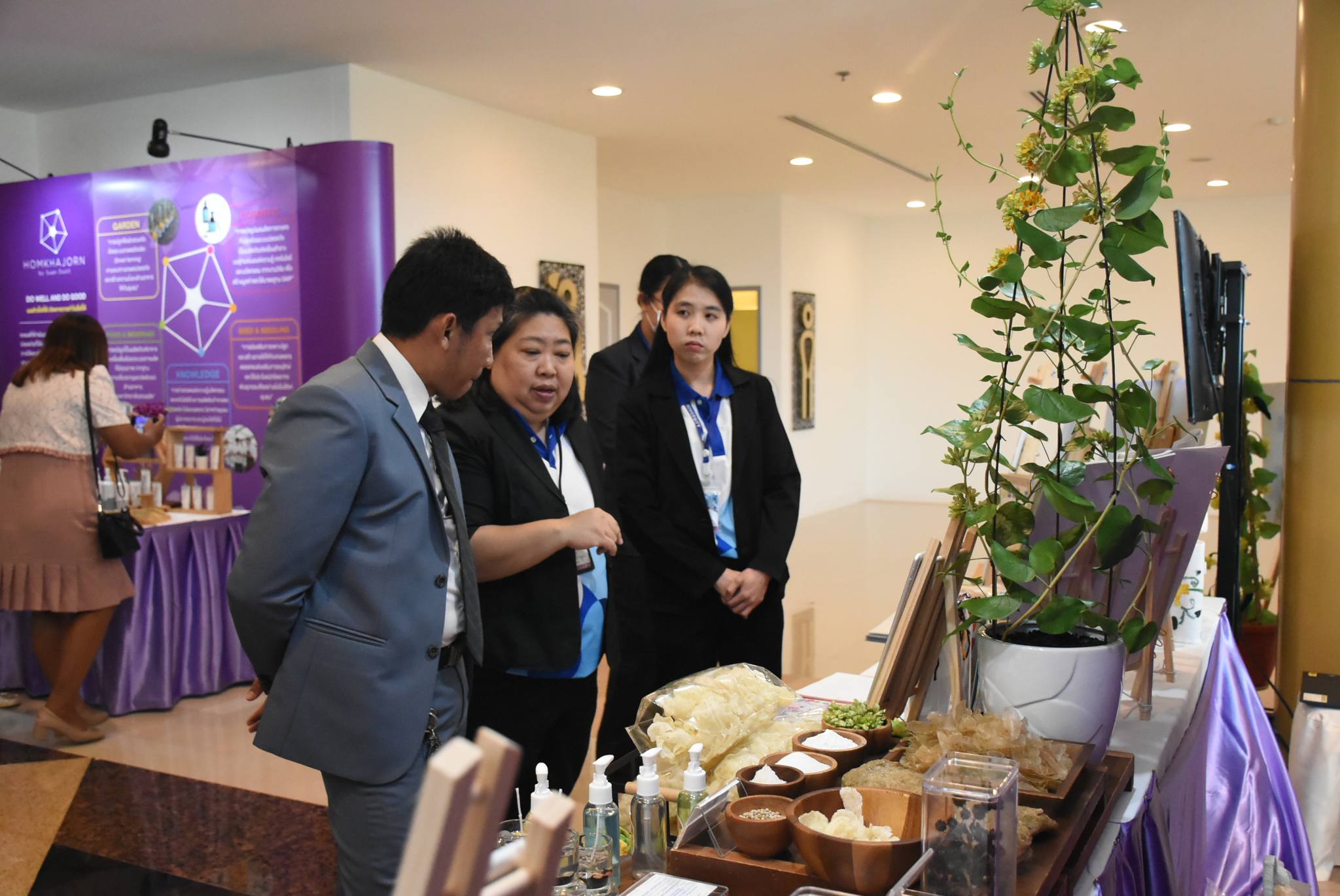 A group of people standing in front of a table

Description automatically generated