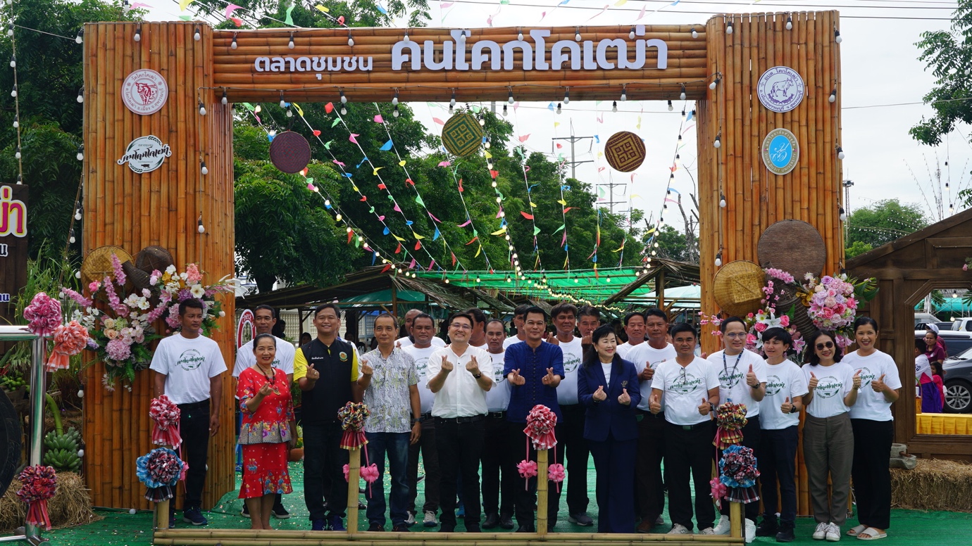 A group of people standing in front of a wooden arch

Description automatically generated