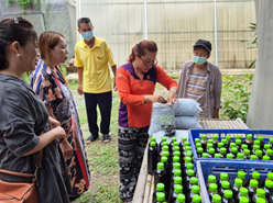 A group of people standing next to a table with bottles

AI-generated content may be incorrect.