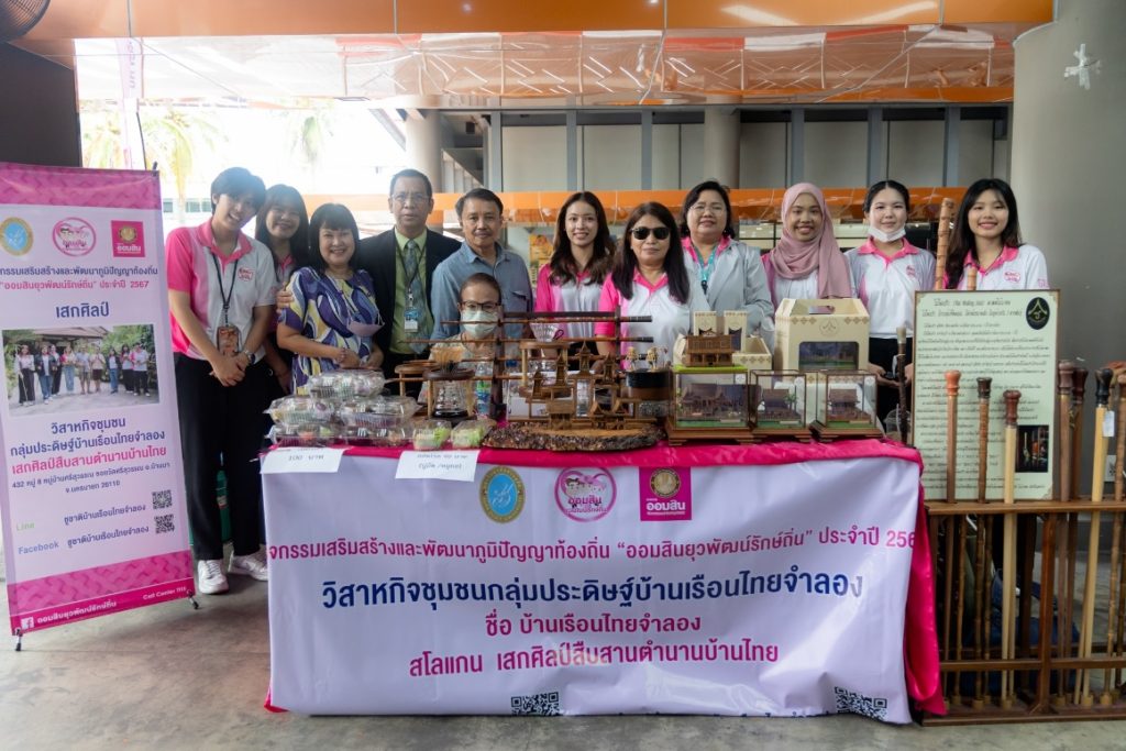 A group of people standing next to a table with objects on it AI-generated content may be incorrect.