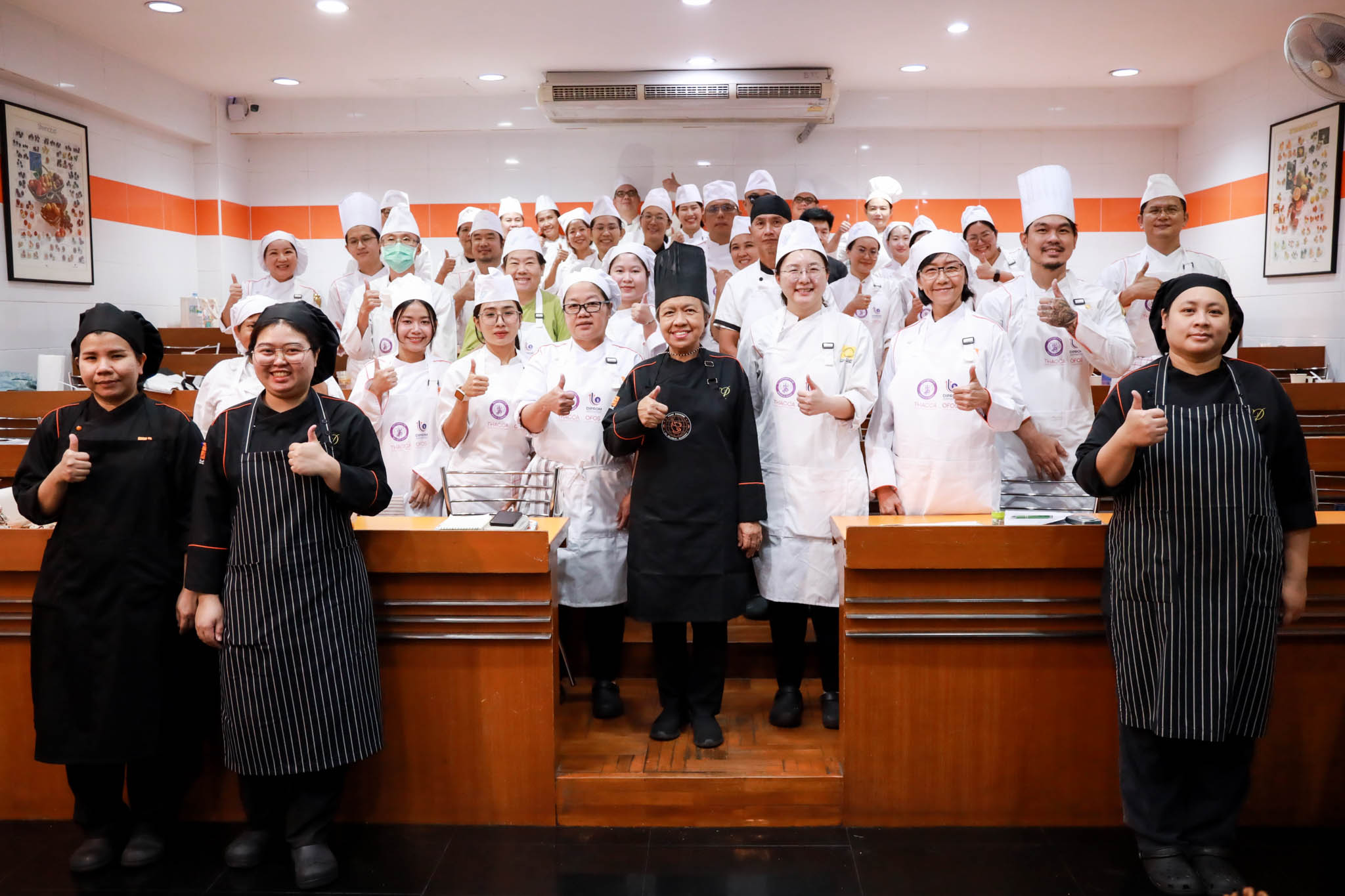 A group of people wearing chef's uniforms
Description automatically generated