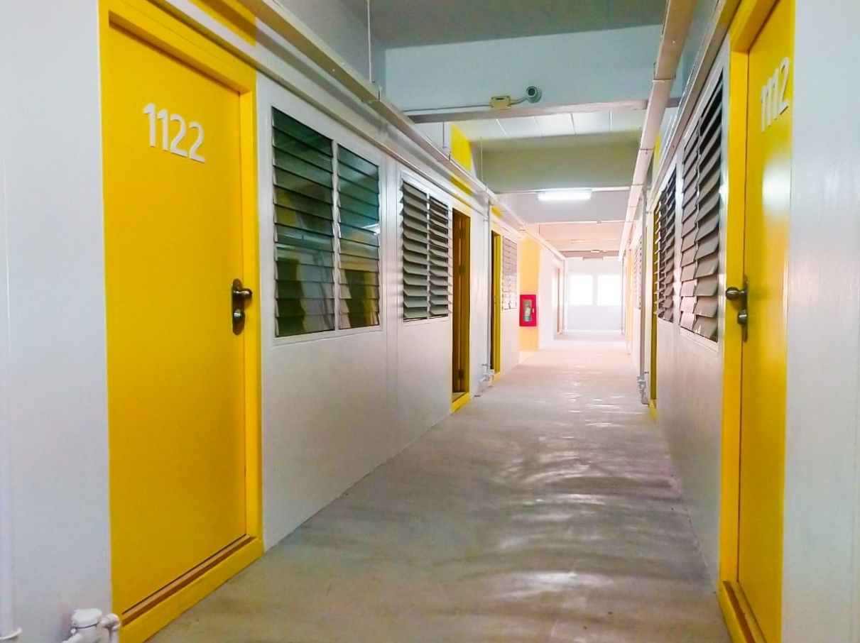 A hallway with yellow doors and blinds

AI-generated content may be incorrect.