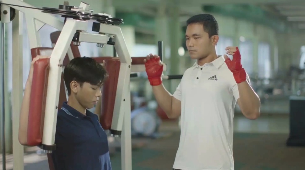 A person in red gloves standing next to a person in a gym

AI-generated content may be incorrect.