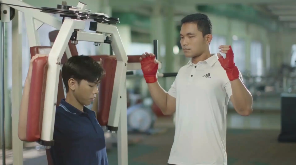 A person in red gloves standing next to a person in a gym

AI-generated content may be incorrect.