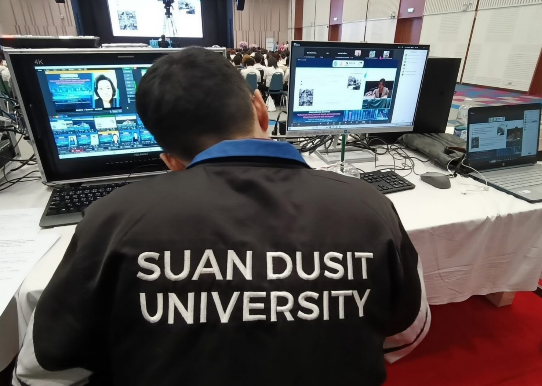 A person sitting at a desk with computers

AI-generated content may be incorrect.