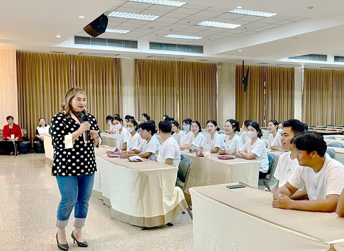 A person standing in front of a group of people
AI-generated content may be incorrect.