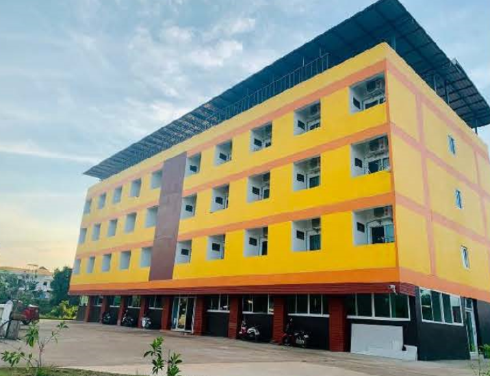 A yellow building with many windows

AI-generated content may be incorrect.