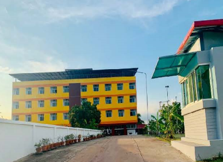 A yellow building with trees and a white fence

AI-generated content may be incorrect.