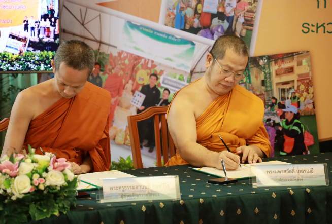 Two men sitting at a table signing papers

AI-generated content may be incorrect.